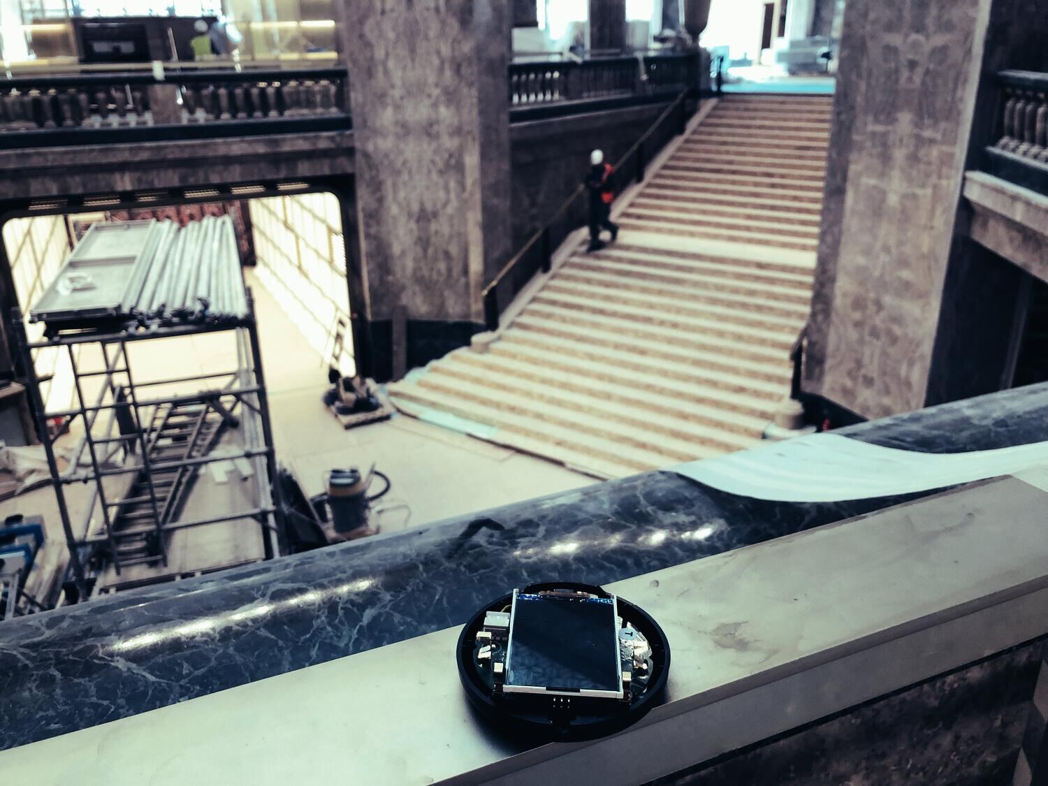 Un boîtier posé sur la rampe de l'escalier en chantier